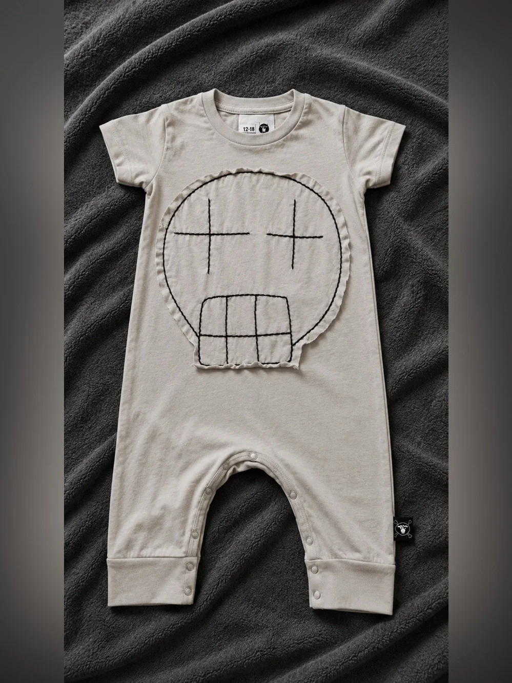 Nununu Beige Baby One-Piece with Skull Patch